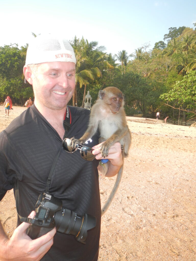 Derrick and a monkey friend on Ao Nang Beach in Thailand