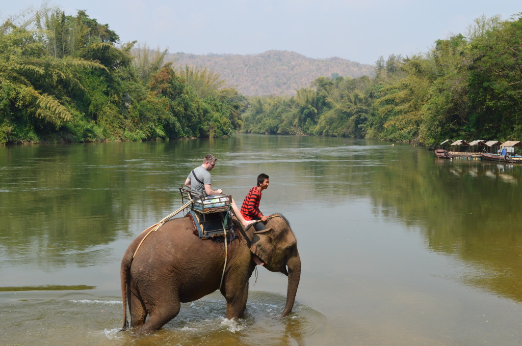 Derrick riding an elephant in Kanchanaburi, Thailand
