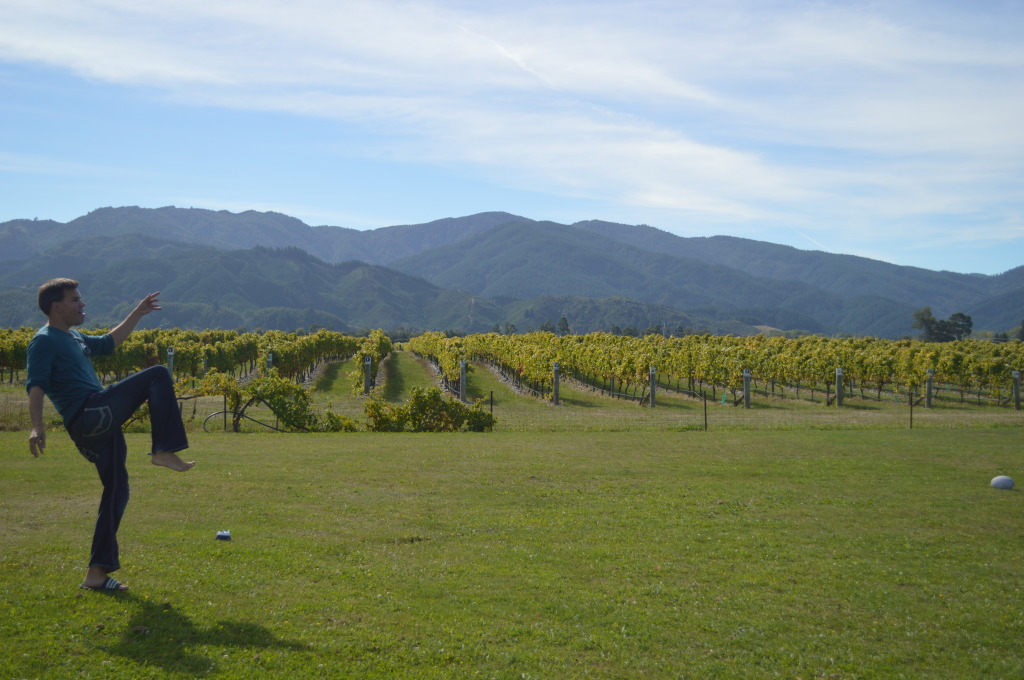 Stephen on a rugby pitch next to a vineyard in Marlborough, New Zealand