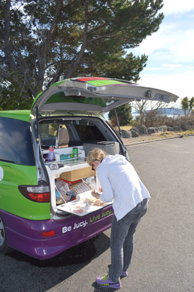 Shannon making lunch in a Jucy Campa Van in New Zealand